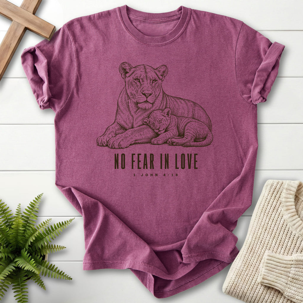 Flat lay of a Berry Comfort Colors 1717 garment-dyed Christian tee featuring "No Fear in Love T-Shirt" 1 John 4:18.