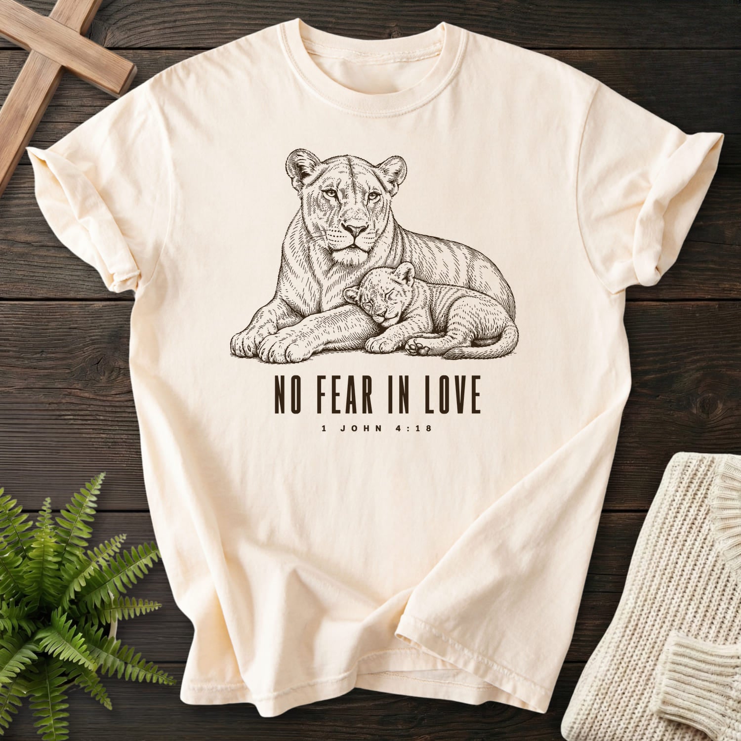 Flatlay of an Ivory Christian shirt with "No Fear in Love T-Shirt" 1 John 4:18 For faith wear collections.