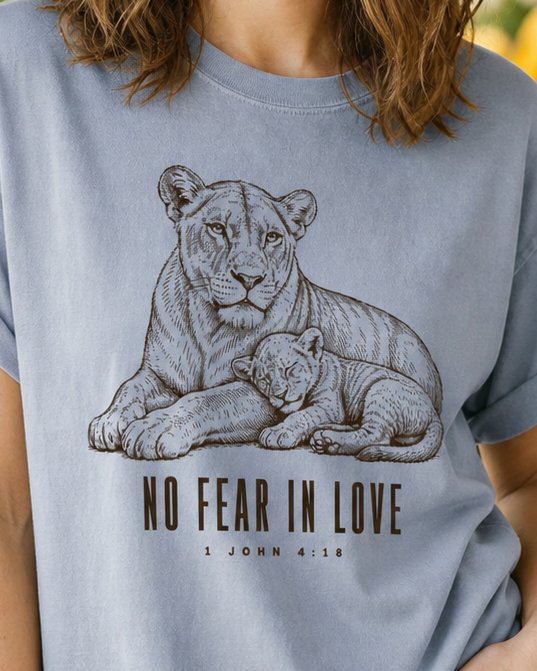 No Fear in Love - Granite women's Christian tee, lifestyle photo in farmers market - Engraved lioness resting with her sleeping cub - 1 John 4:18 - She Wears Faith