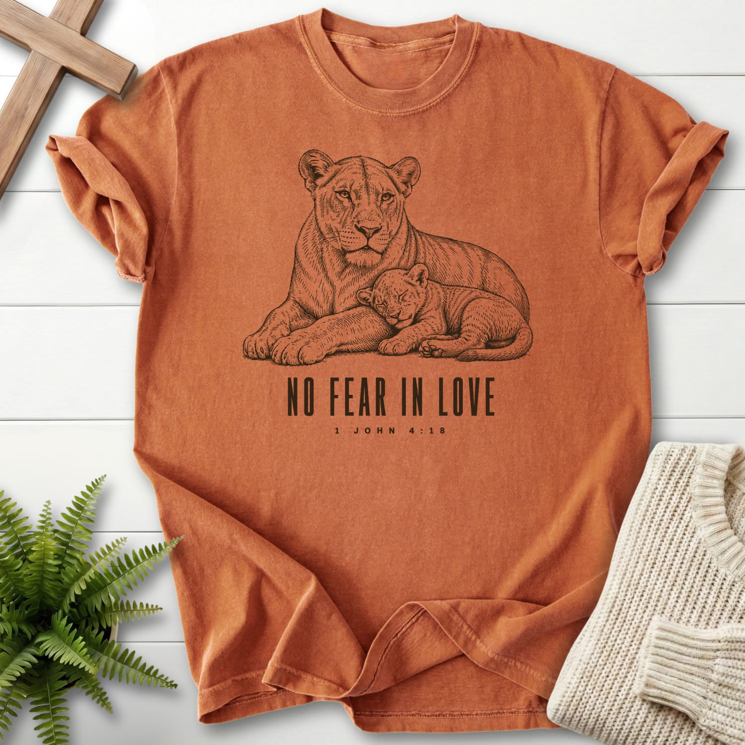 Flat lay of a Yam faith-based tee featuring "No Fear in Love T-Shirt" 1 John 4:18.