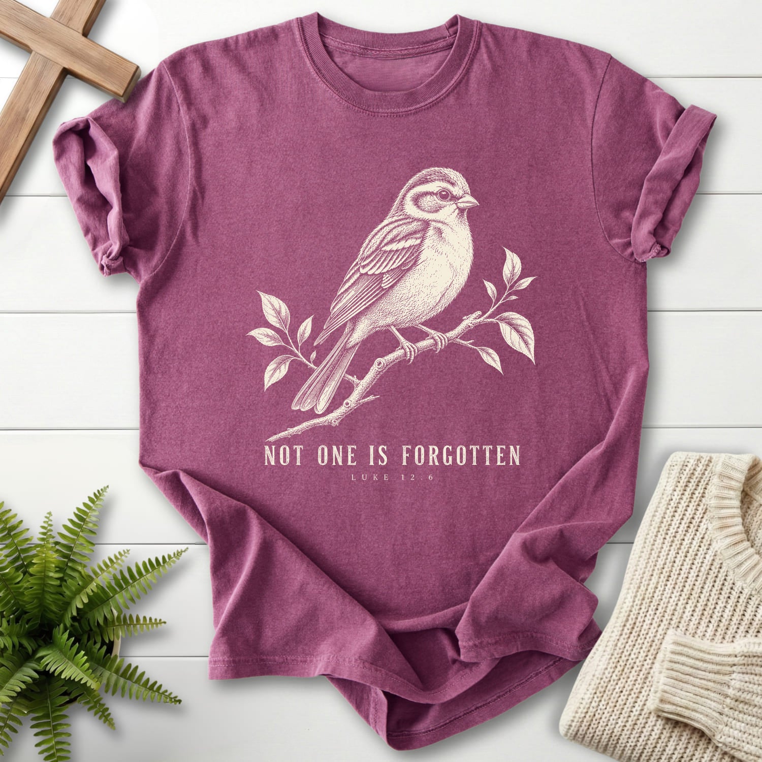 Flat lay of a Berry Christian shirt featuring "Not One Is Forgotten Luke 12:6 T-Shirt" design.