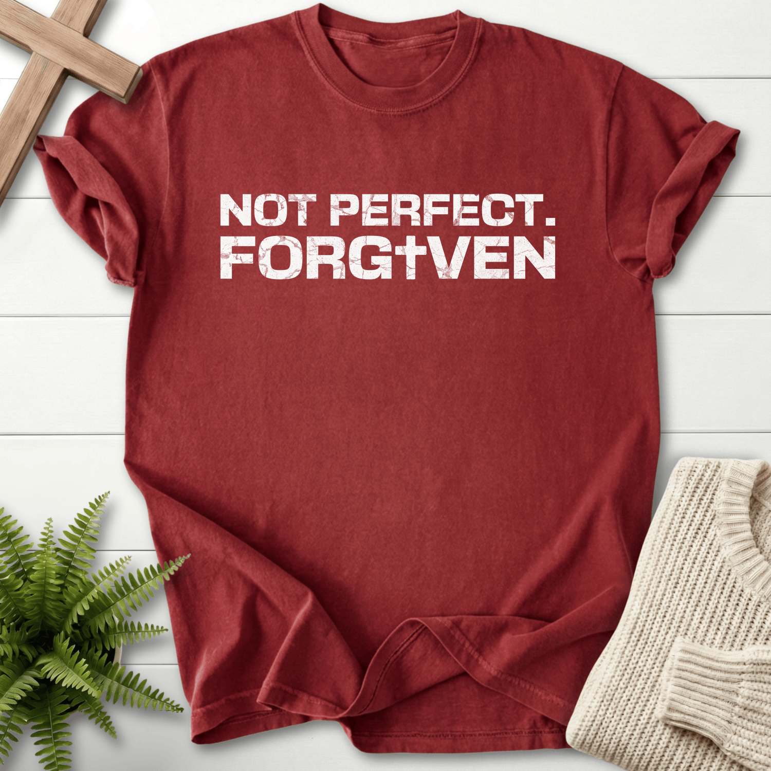 Brick women's Christian t-shirt with distressed 'Not Perfect. Forgiven' white block text and cross emblem.