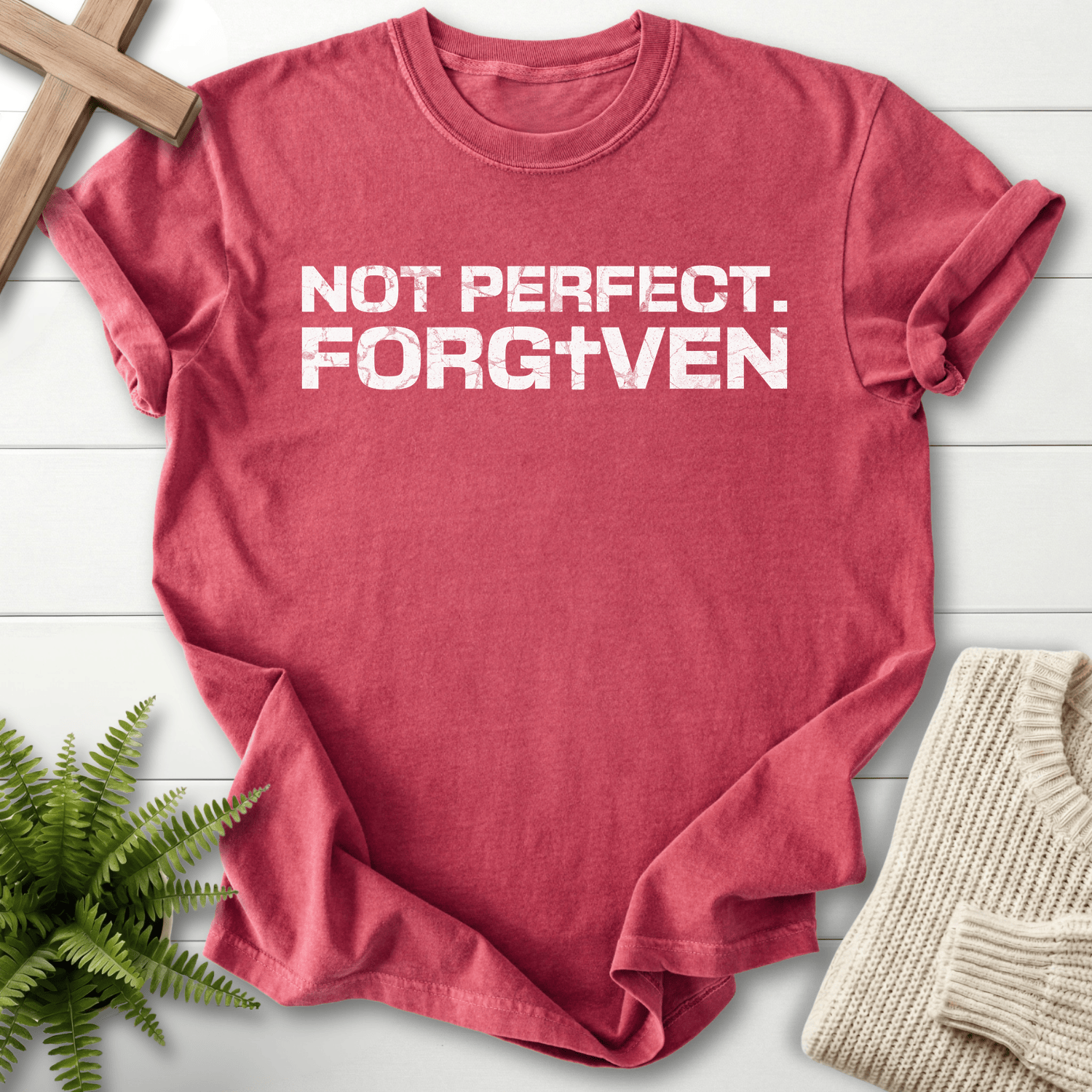 Crimson women's Christian t-shirt with grunge block 'Not Perfect. Forgiven' text and cross.