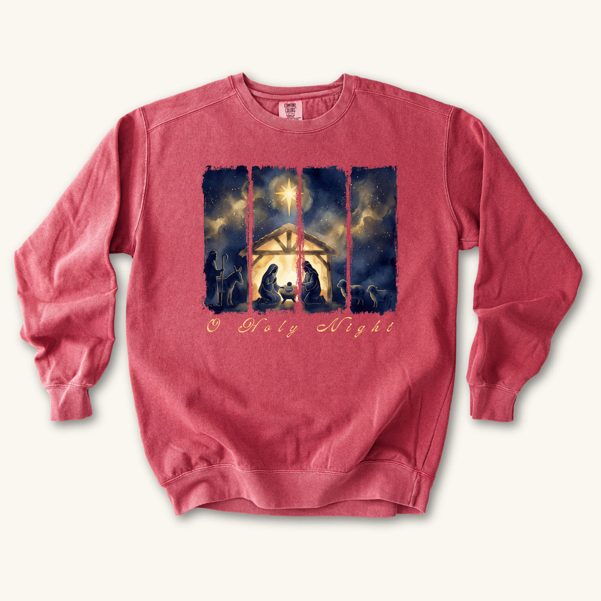 Crimson Christian Christmas sweatshirt with a painted nativity of Mary, Joseph and the manger in a glowing stable under a bright star, with O Holy Night in script.