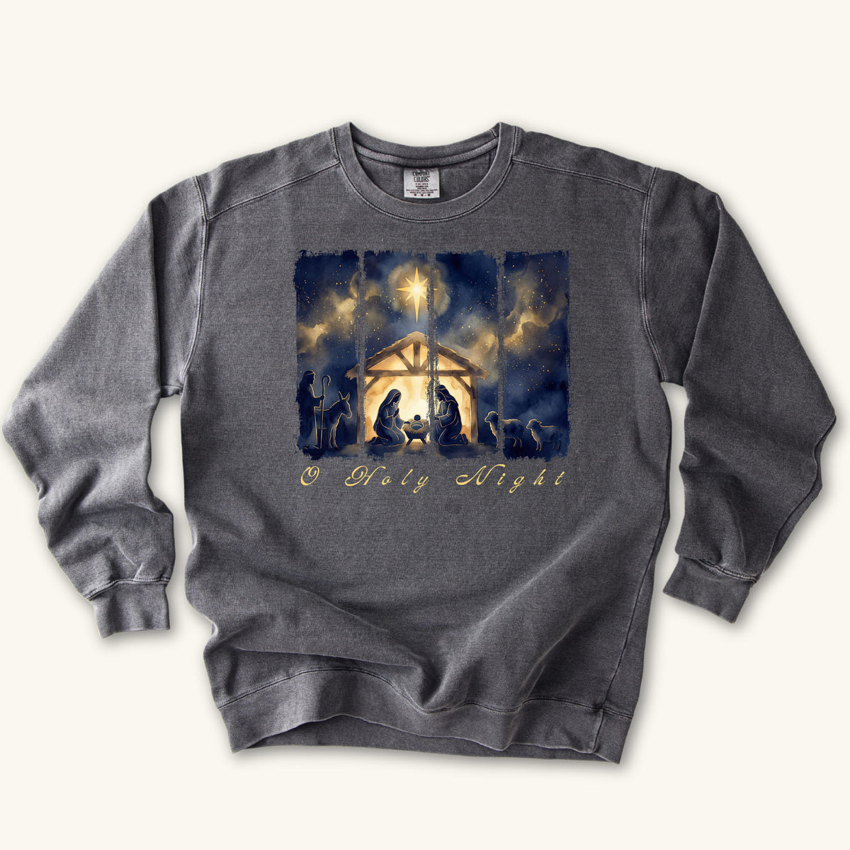 Pepper Christian Christmas sweatshirt with a painted nativity of Mary, Joseph and the manger in a glowing stable under a bright star, with O Holy Night in script.