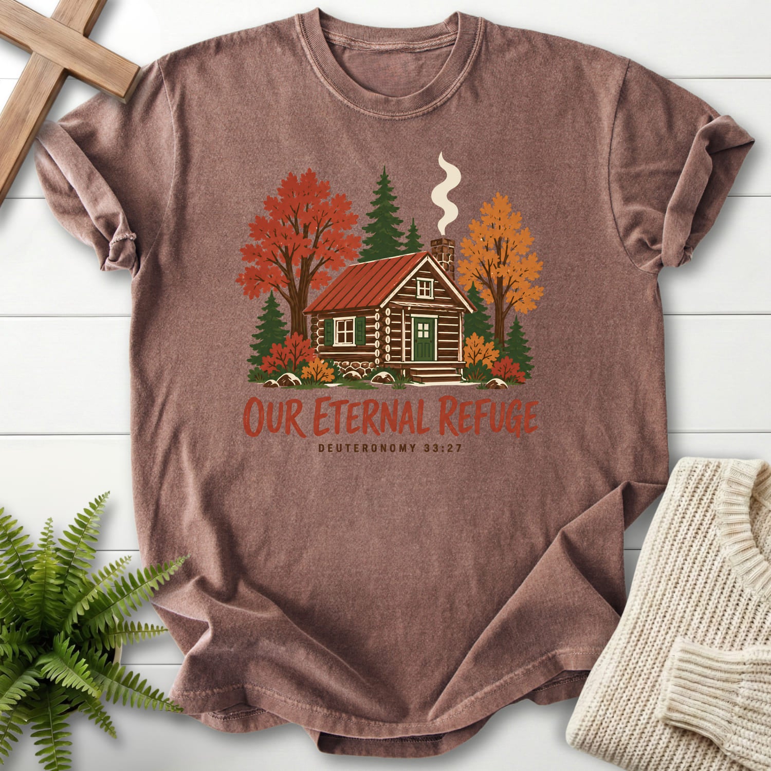 Flatlay of an Espresso women's Christian tee with "Our Eternal Refuge Autumn Faith T-Shirt" Deuteronomy 33:27.