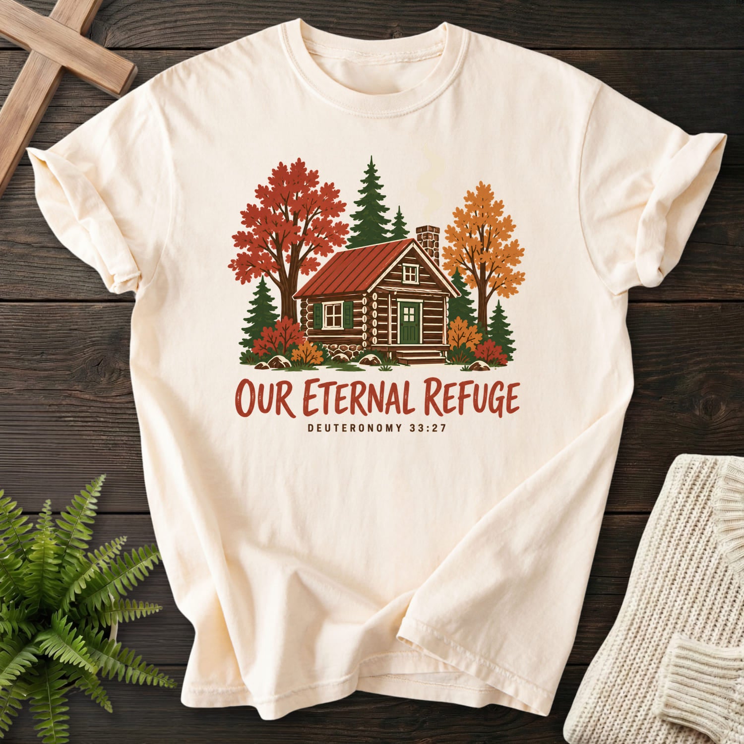 Flat lay of an Ivory Comfort Colors 1717 Christian shirt featuring "Our Eternal Refuge Autumn Faith T-Shirt" Deuteronomy 33:27.