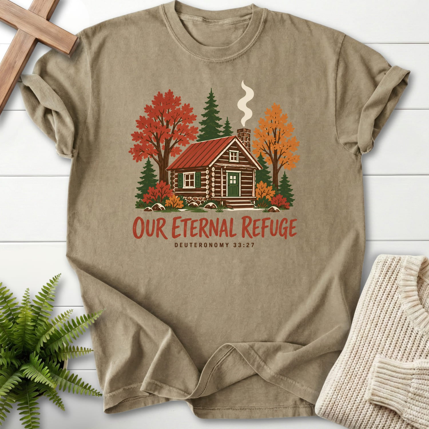 Flatlay of a Khaki Christian t-shirt for women with "Our Eternal Refuge Autumn Faith T-Shirt" Deuteronomy 33:27 From Printify.