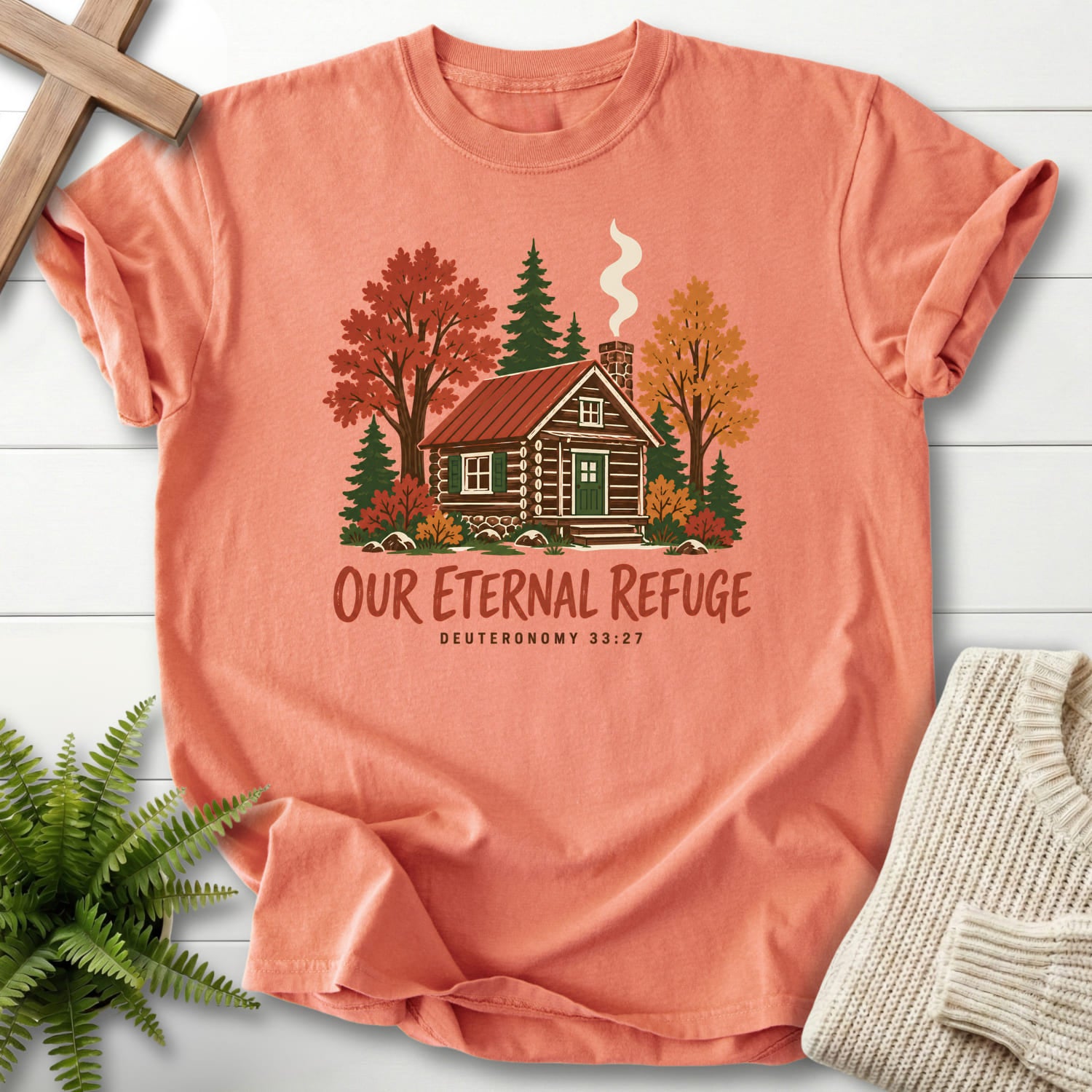 Flat lay of a Terracotta Scripture shirt featuring "Our Eternal Refuge Autumn Faith T-Shirt" Deuteronomy 33:27.