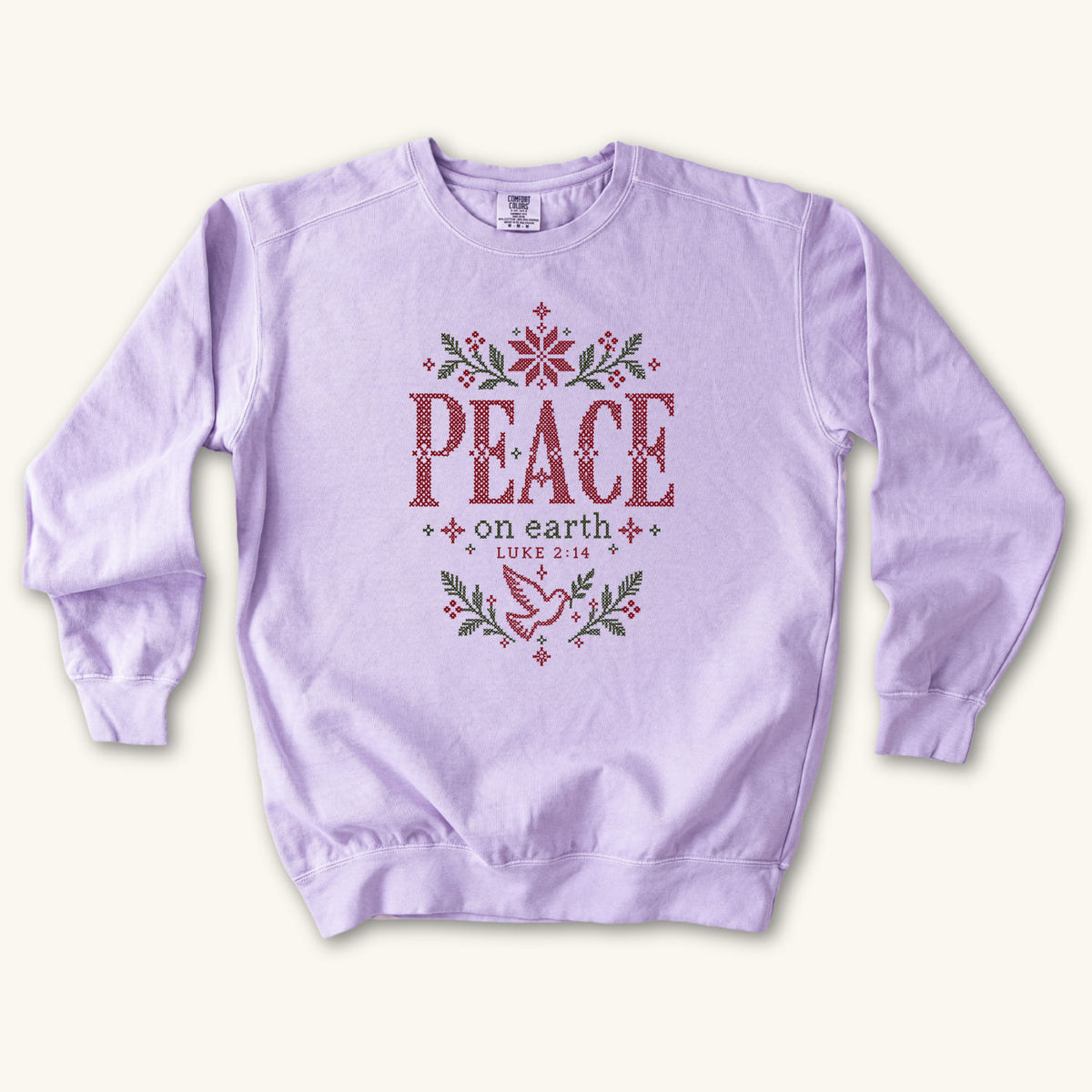 Orchid Christian Christmas sweatshirt with cross-stitch style Peace on Earth lettering, a dove, stars, branches and Luke 2:14.