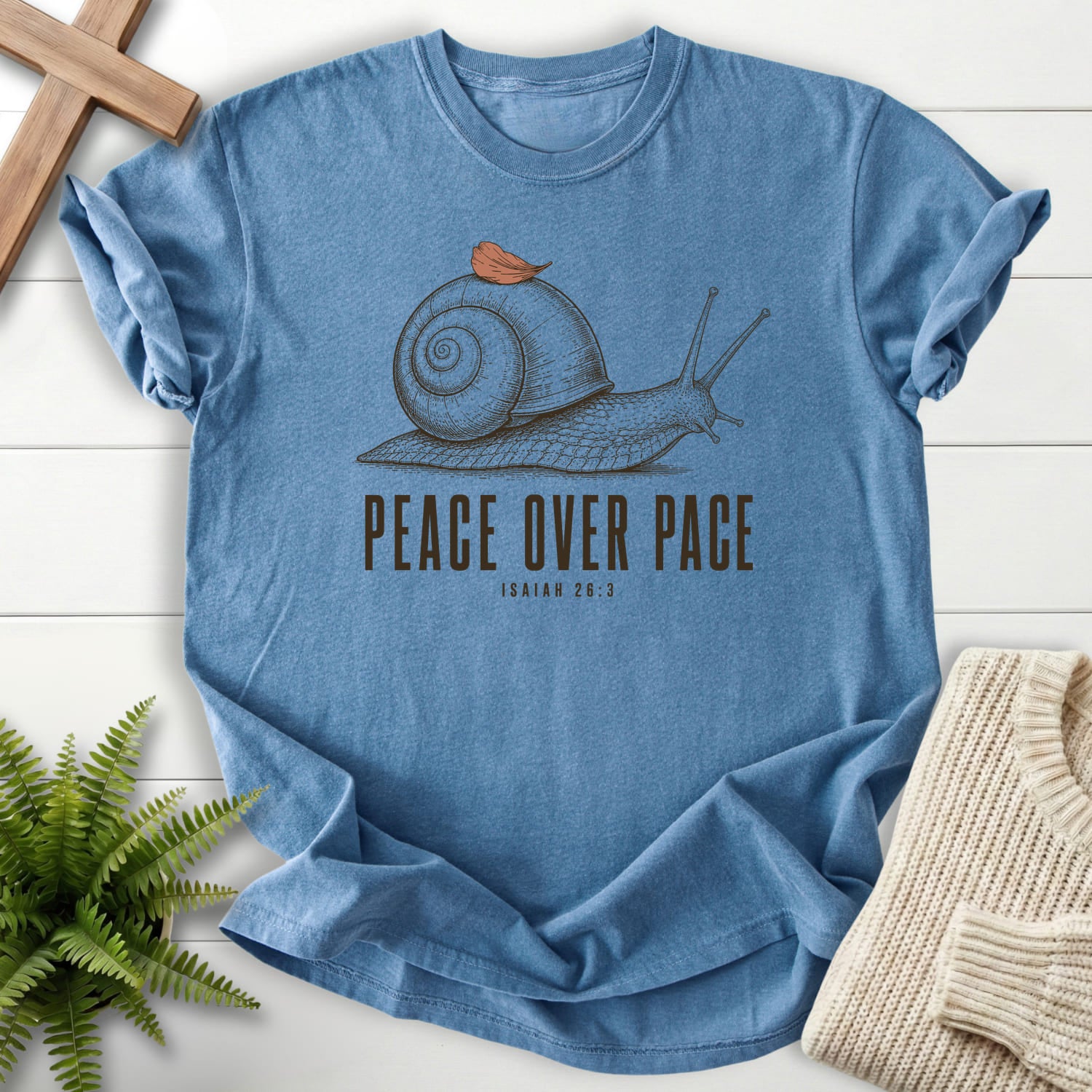 Flatlay of a Blue Jean Comfort Colors 1717 garment-dyed Christian tee with "Peace Over Pace Isaiah 26:3 T-Shirt" Isaiah 26:3.