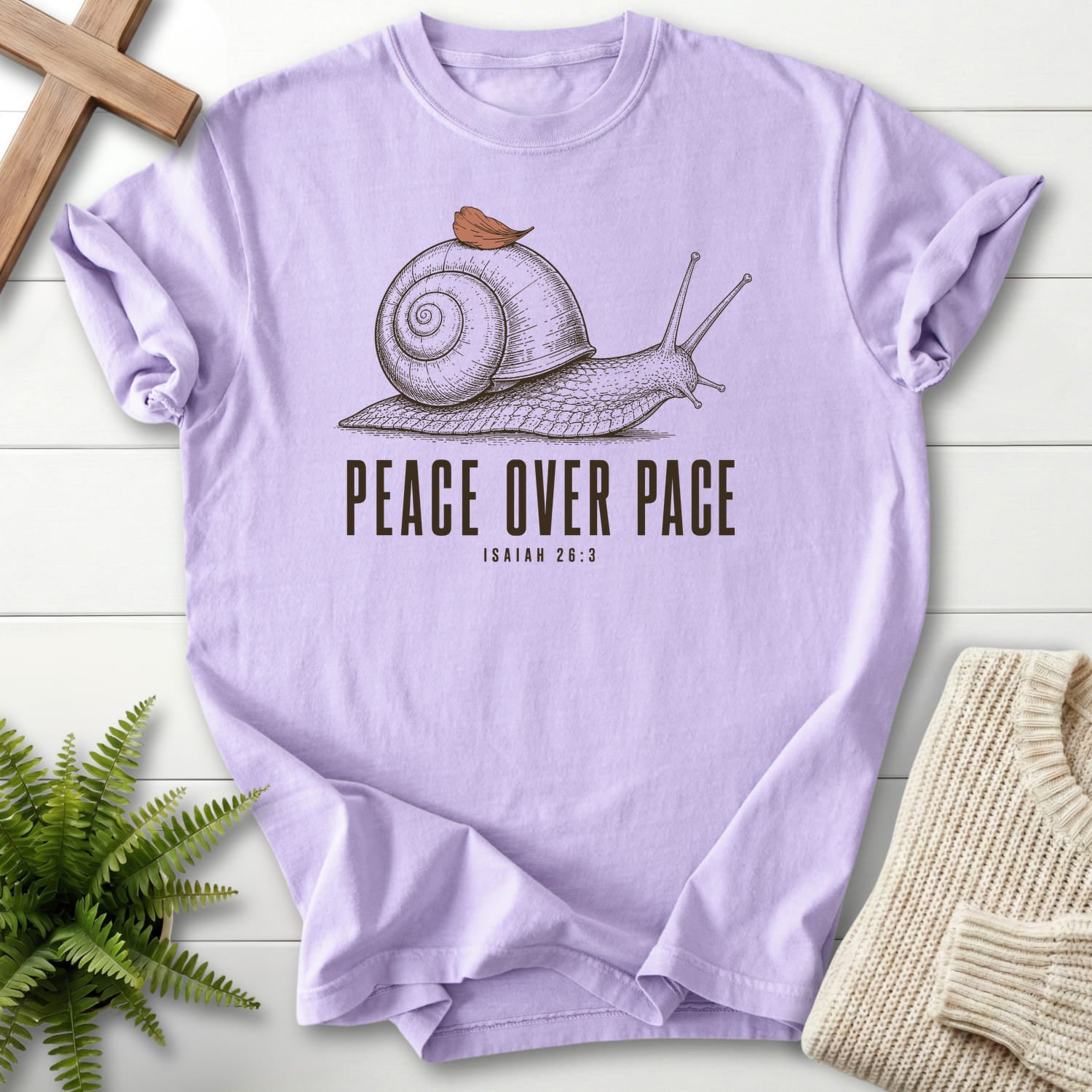 Flat lay of an Orchid Christian t-shirt for women featuring "Peace Over Pace Isaiah 26:3 T-Shirt" Isaiah 26:3.