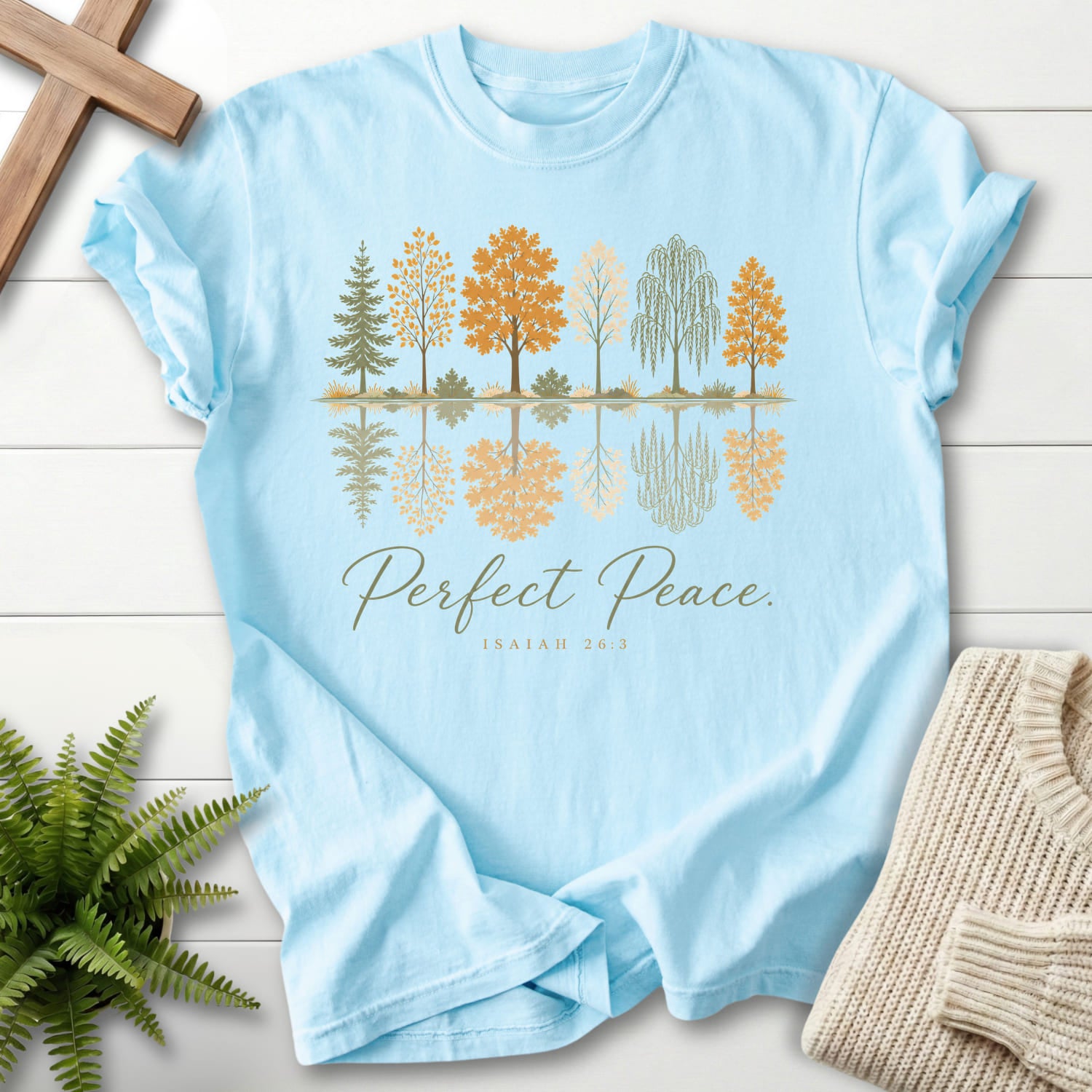 Flatlay of a Chambray Christian t-shirt for women with script typography with "Perfect Peace Isaiah 26:3 T-Shirt" Isaiah 26:3 From Printify.