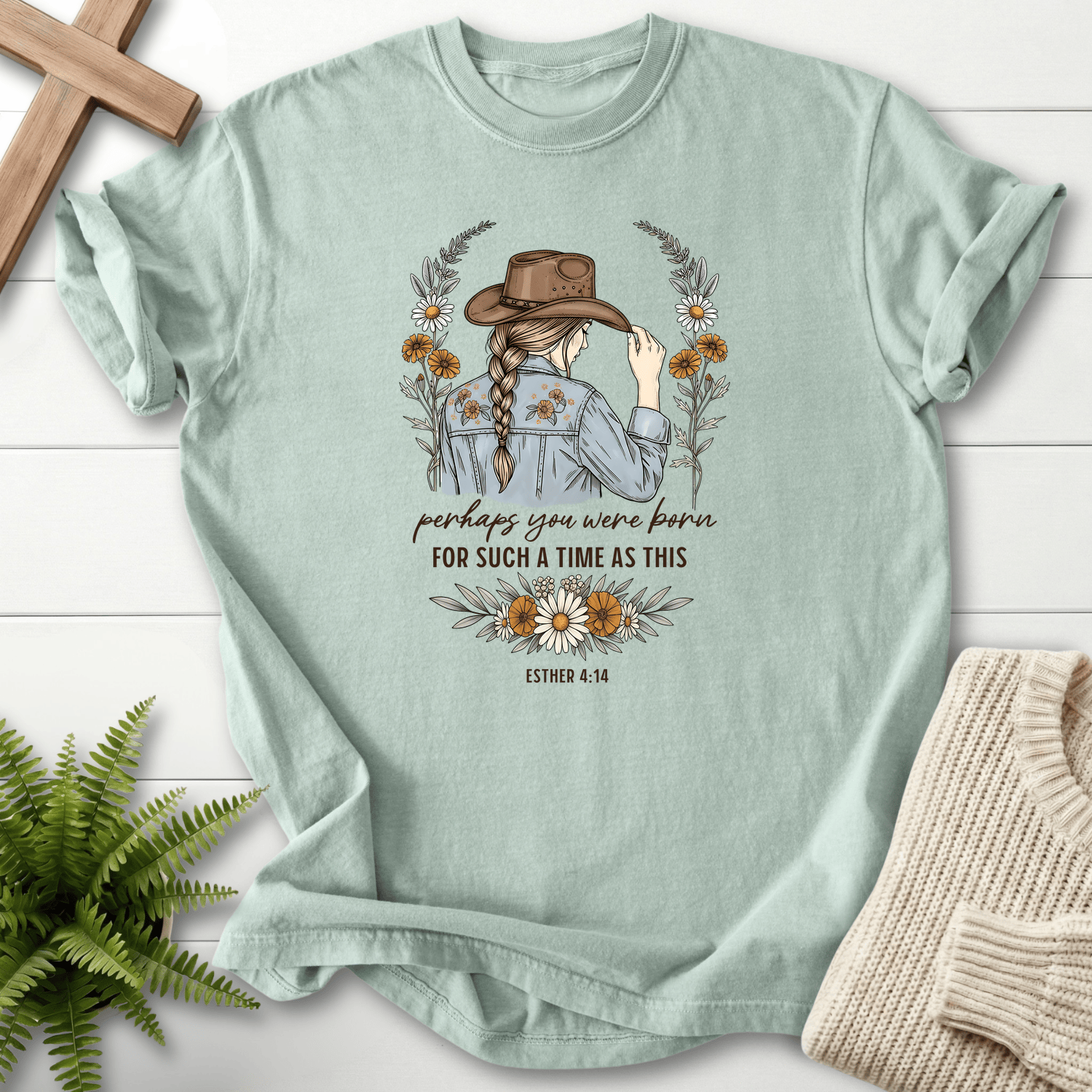 Bay women's Bible verse tee with a woman in a cowboy hat surrounded by wildflowers, inspired by Esther 4:14.