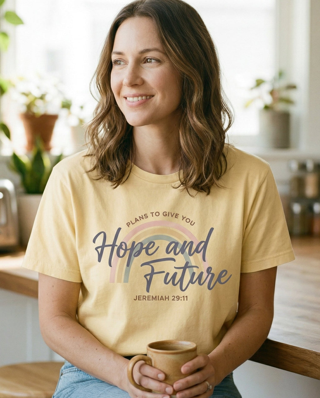 Hope and Future – Banana women's Christian tee, lifestyle photo in morning kitchen setting – Soft pastel rainbow arc with 'Plans to Give You Hope and Future' in mi – Jeremiah 29:11 – She Wears Faith