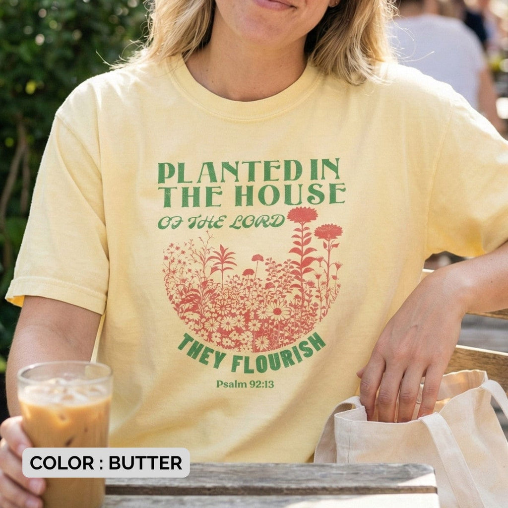 Smiling woman drinking iced coffee wearing a Butter Yellow Comfort Colors 1717 tshirt. Lifestyle photography of a Christian women tee with Psalm 92:13, showcasing casual US faith wear.