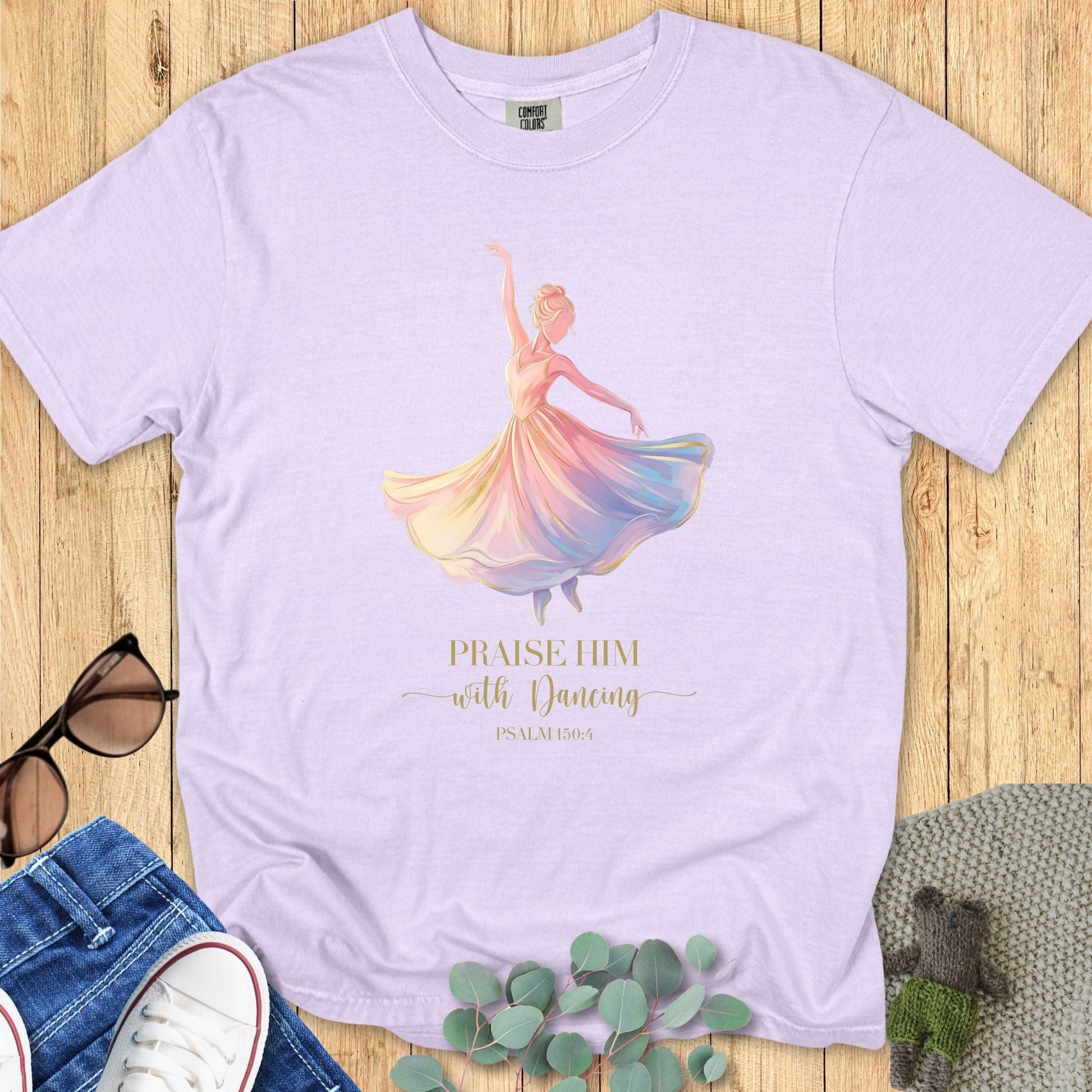Comfort Colors 1717 Christian women t-shirt in orchid purple flat lay. Faith-based design with watercolor ballerina and scripture verse “Praise Him with Dancing – Psalm 150:4.