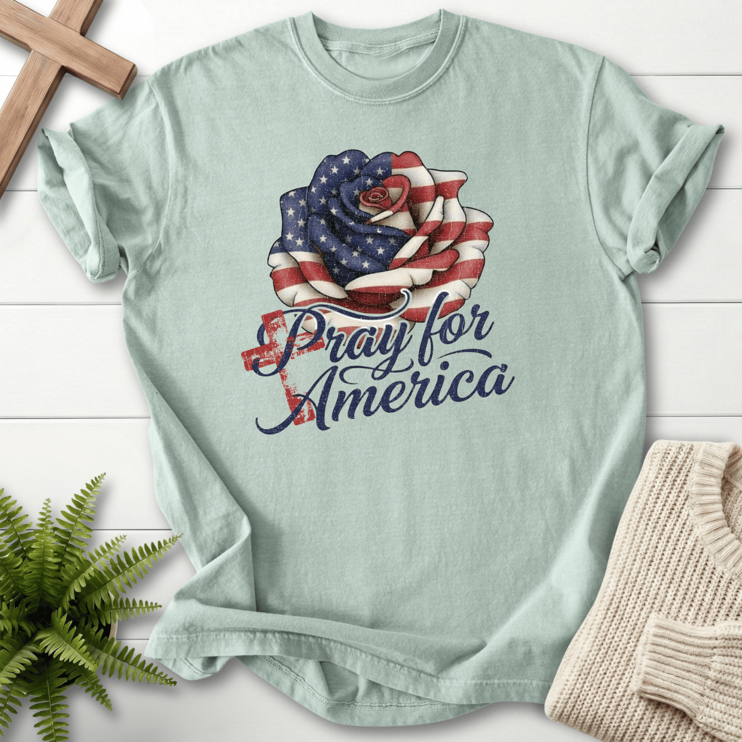 Bay women's Christian t-shirt with American flag rose illustration and "Pray for America" text.