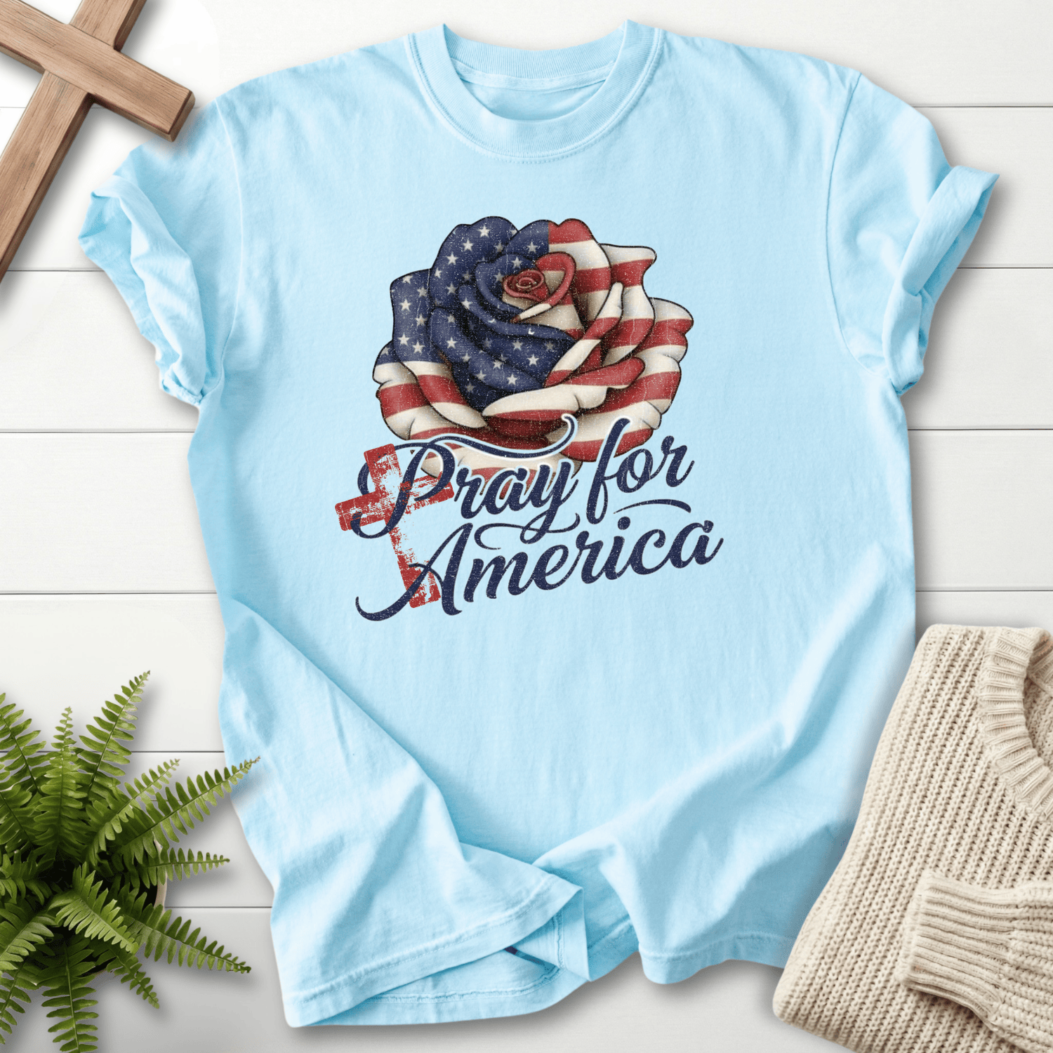 Chambray women's Christian t-shirt with patriotic flag rose and cursive "Pray for America" with cross motif.