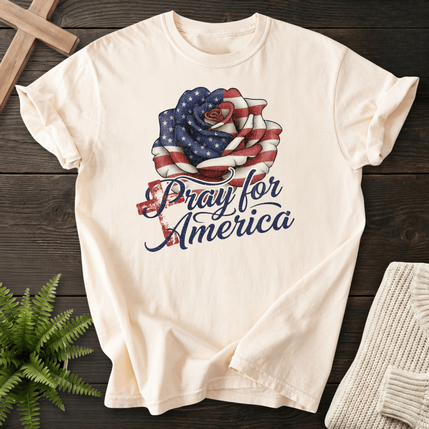 Ivory women's Christian t-shirt with American flag rose and "Pray for America" cursive script.