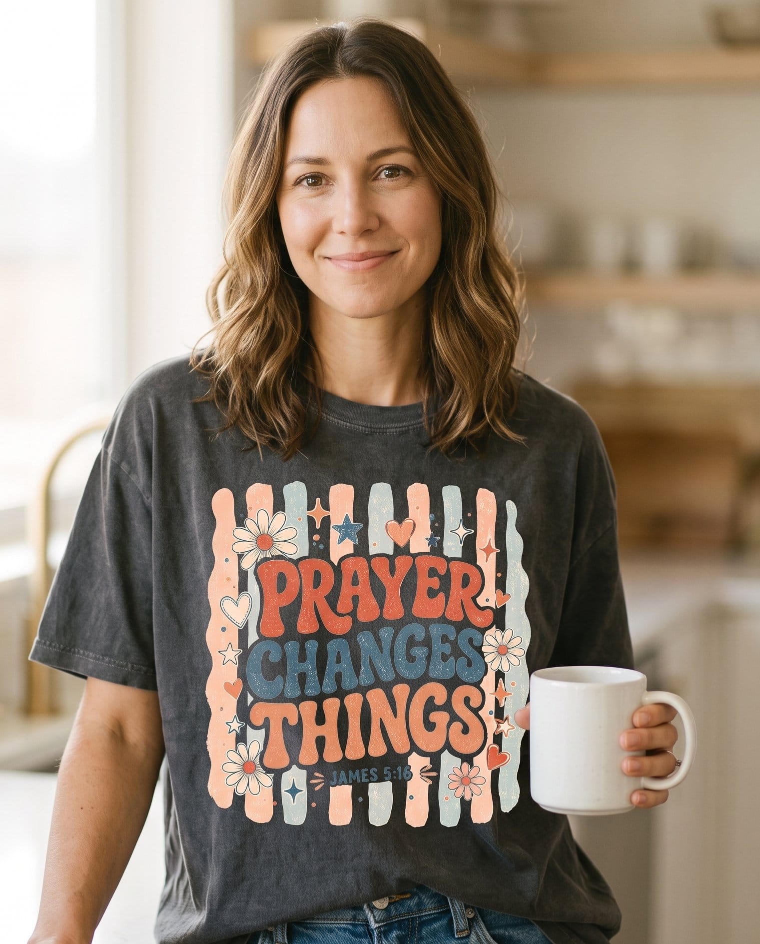 Prayer Changes Things James 5:16 – Pepper women's Christian tee, lifestyle photo in morning kitchen setting – Retro lettering "Prayer Changes Things" with daisies – James 5:16 – She Wears Faith