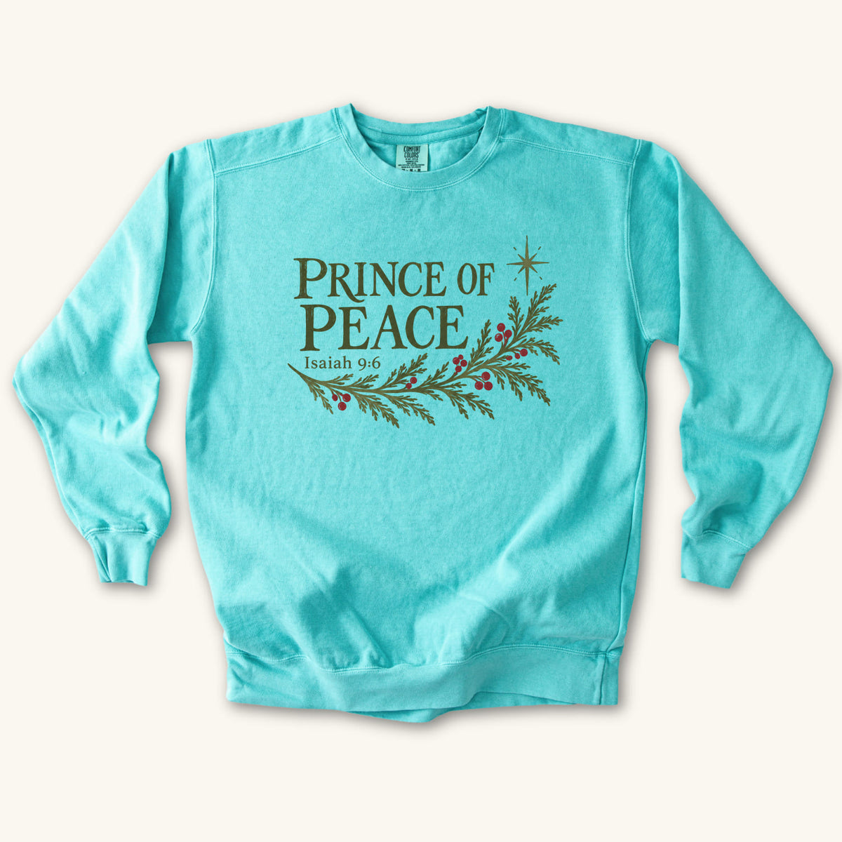 Chalky Mint Christian Christmas sweatshirt with Prince of Peace lettering, an evergreen branch with red berries, a star and Isaiah 9:6.
