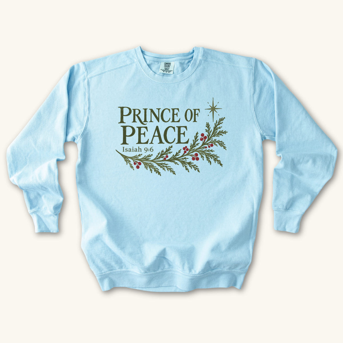 Chambray Christian Christmas sweatshirt with Prince of Peace lettering, an evergreen branch with red berries, a star and Isaiah 9:6.