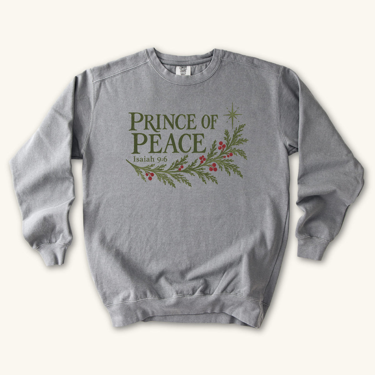 Grey Christian Christmas sweatshirt with Prince of Peace lettering, an evergreen branch with red berries, a star and Isaiah 9:6.