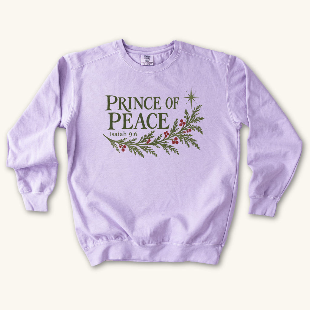 Orchid Christian Christmas sweatshirt with Prince of Peace lettering, an evergreen branch with red berries, a star and Isaiah 9:6.