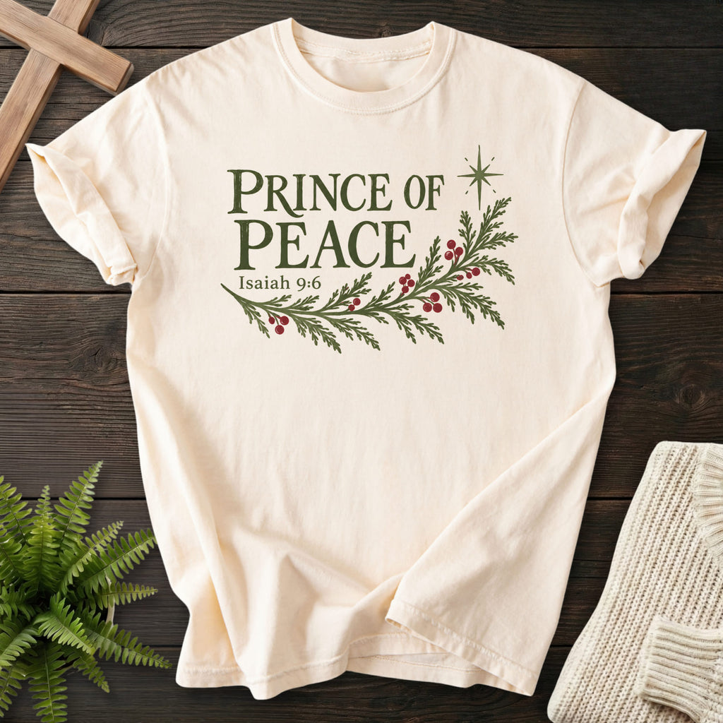 Flat lay of an Ivory Comfort Colors 1717 faith-based tee featuring vine and grape artwork with "Prince of Peace T-Shirt" Isaiah 9:6.