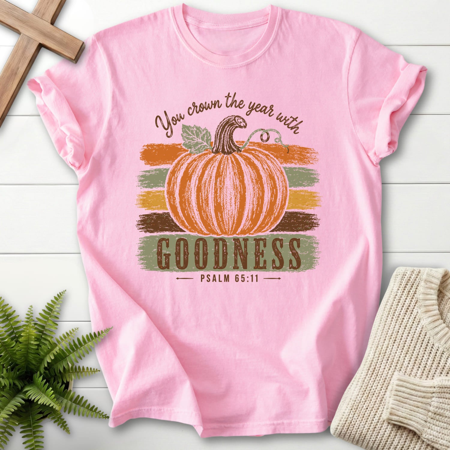 Flatlay of a Blossom Comfort Colors 1717 Christian graphic tee with "Pumpkin Goodness Psalm 65 11 Goodness T-Shirt" Psalm 65:11.
