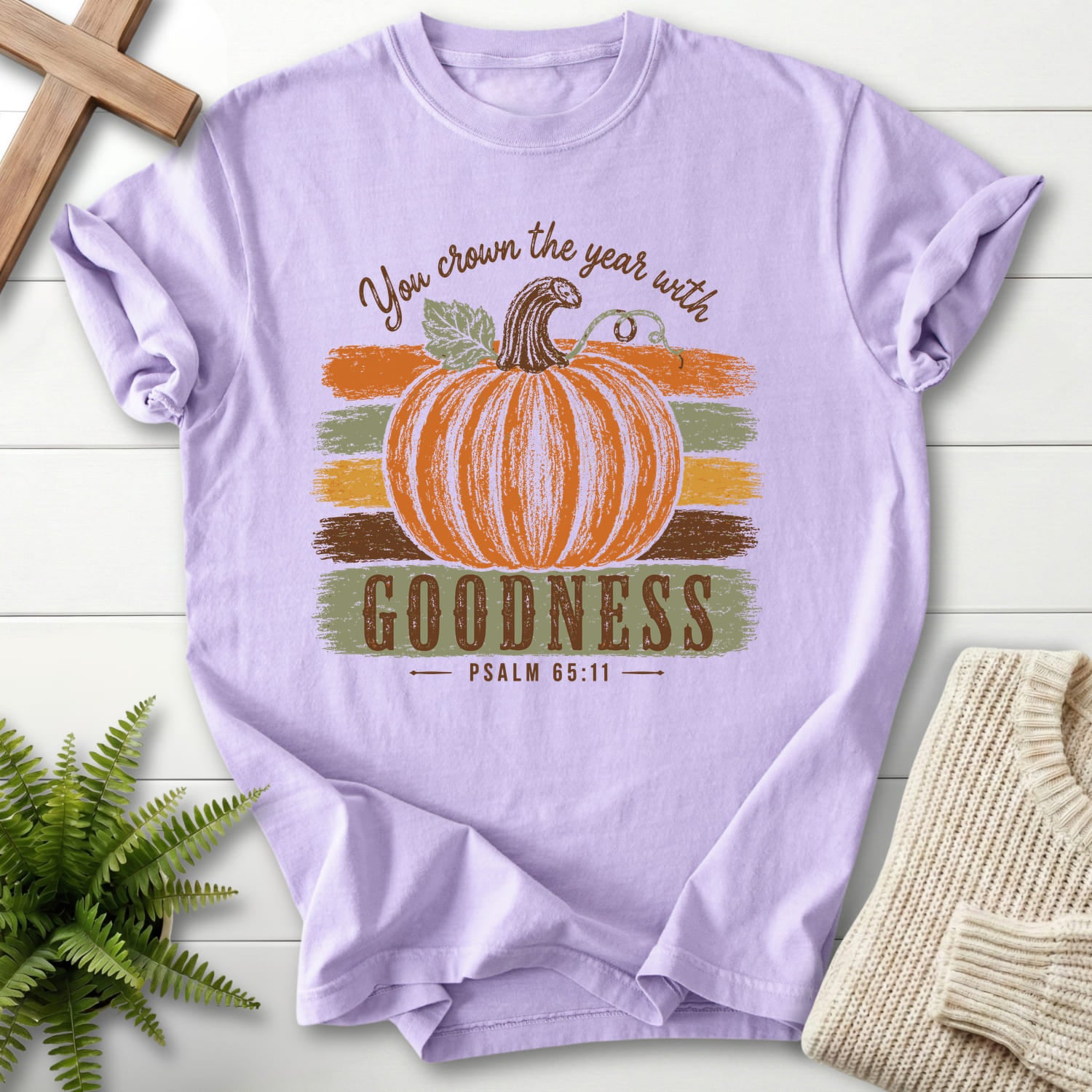 Flatlay of an Orchid Christian shirt with "Pumpkin Goodness Psalm 65 11 Goodness T-Shirt" Psalm 65:11.