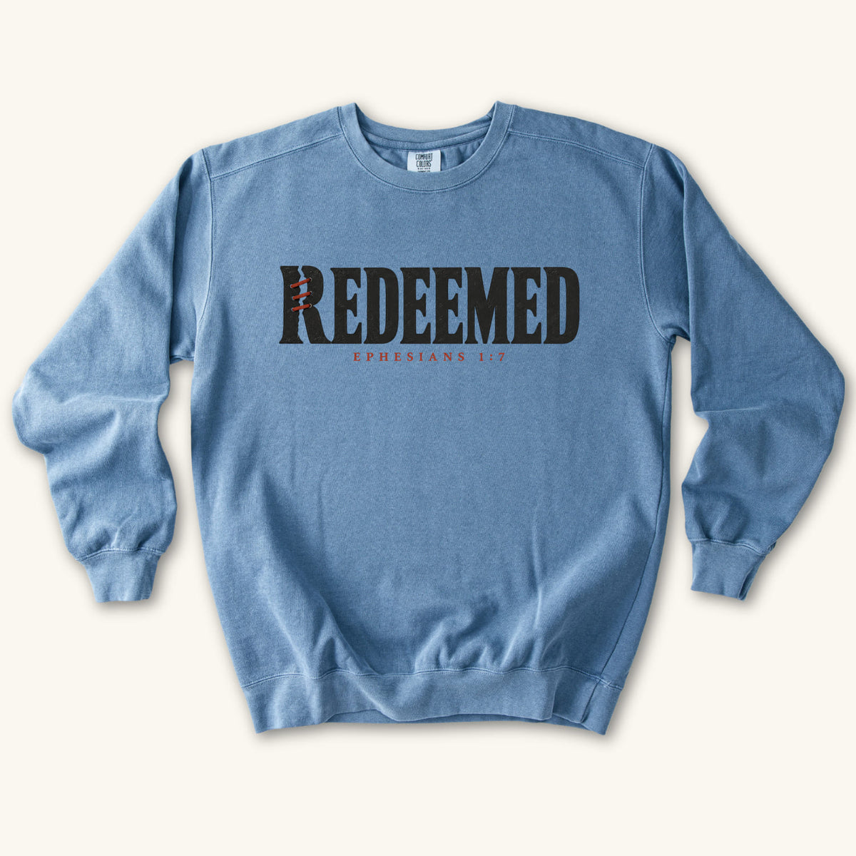 Blue Jean Redeemed sweatshirt flat lay mockup, Ephesians 1:7 Christian apparel for women