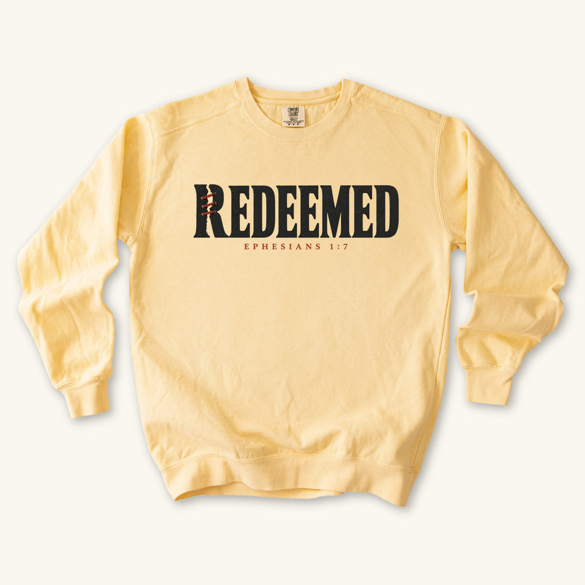Butter Redeemed sweatshirt flat lay mockup, Ephesians 1:7 Christian apparel for women