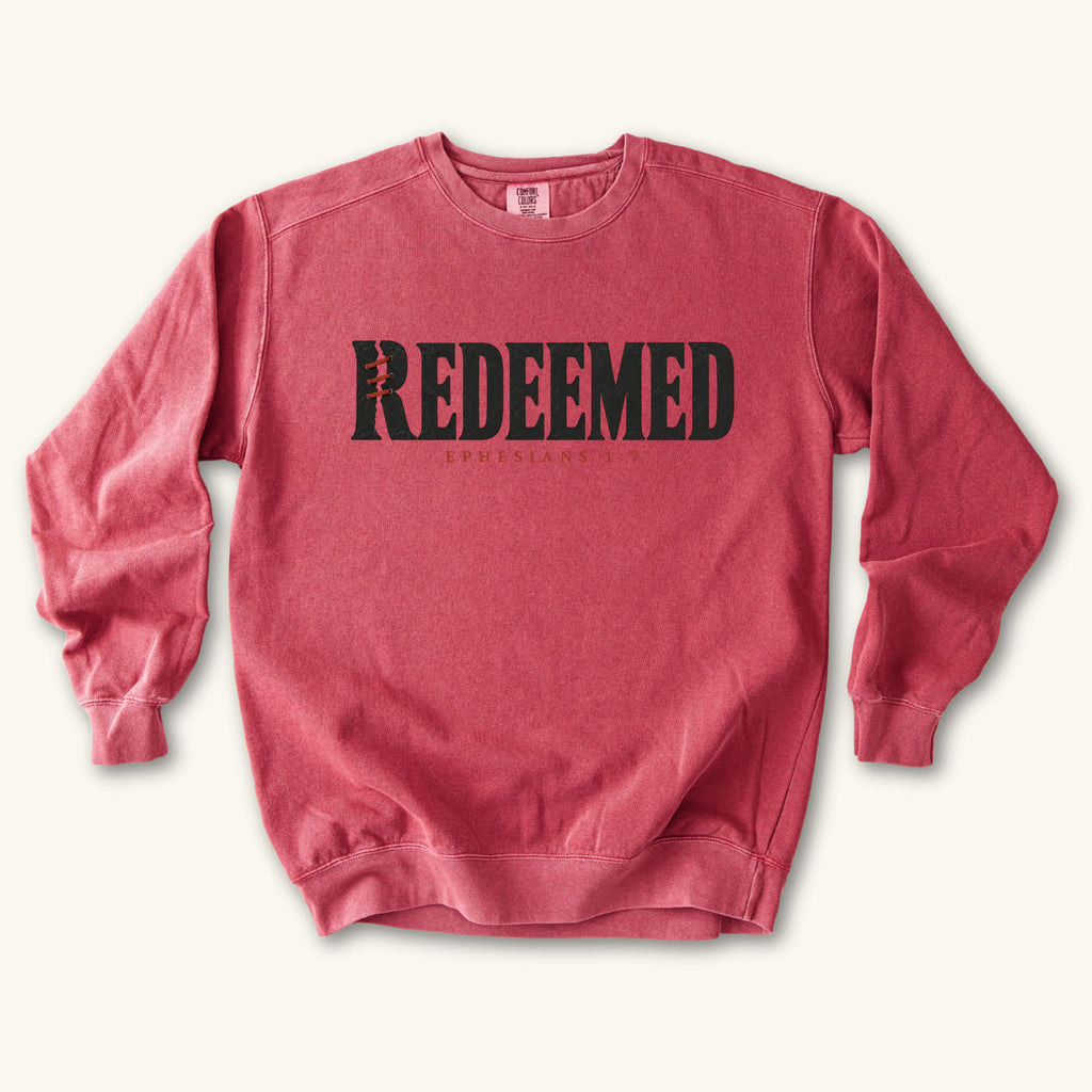 Crimson Redeemed sweatshirt flat lay mockup, Ephesians 1:7 Christian apparel for women