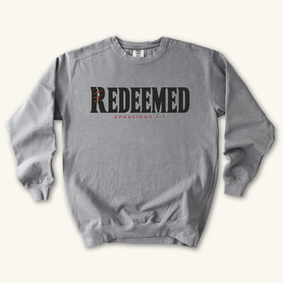 Grey Redeemed sweatshirt flat lay mockup, Ephesians 1:7 Christian apparel for women