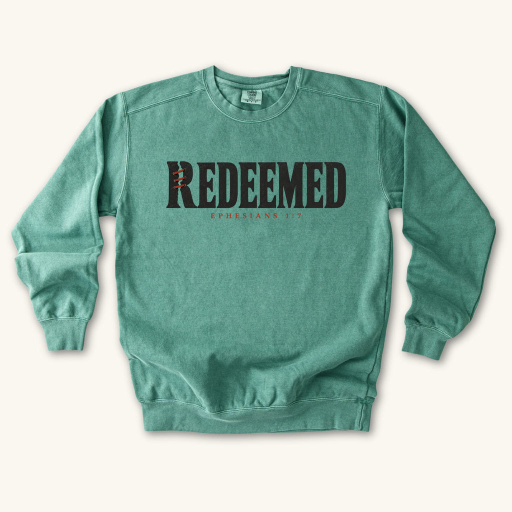Light Green Redeemed sweatshirt flat lay mockup, Ephesians 1:7 Christian apparel for women