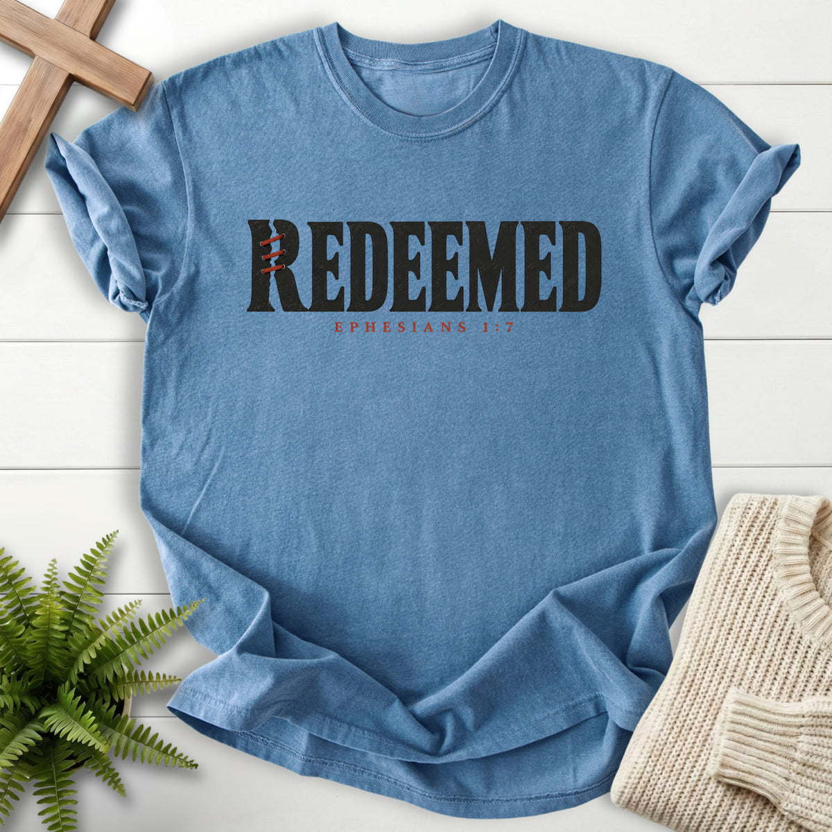 Blue Jean Redeemed T-shirt flat lay mockup, Ephesians 1:7 Christian apparel for women