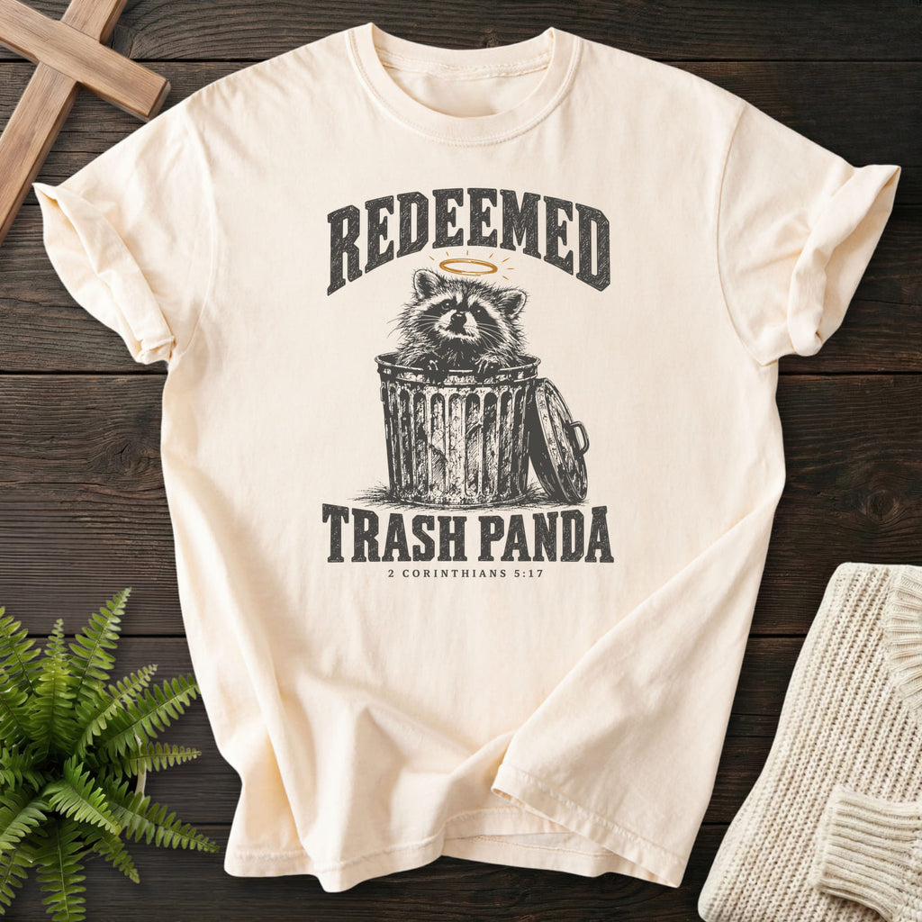 Ivory Redeemed Trash Panda T-shirt flat lay mockup, 2 Corinthians 5:17 Christian apparel for women