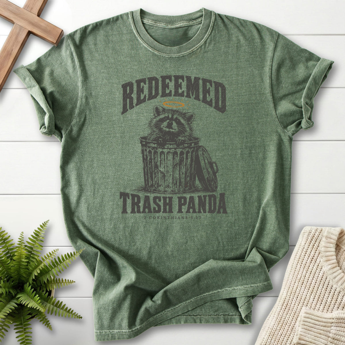 Moss Redeemed Trash Panda T-shirt flat lay mockup, 2 Corinthians 5:17 Christian apparel for women
