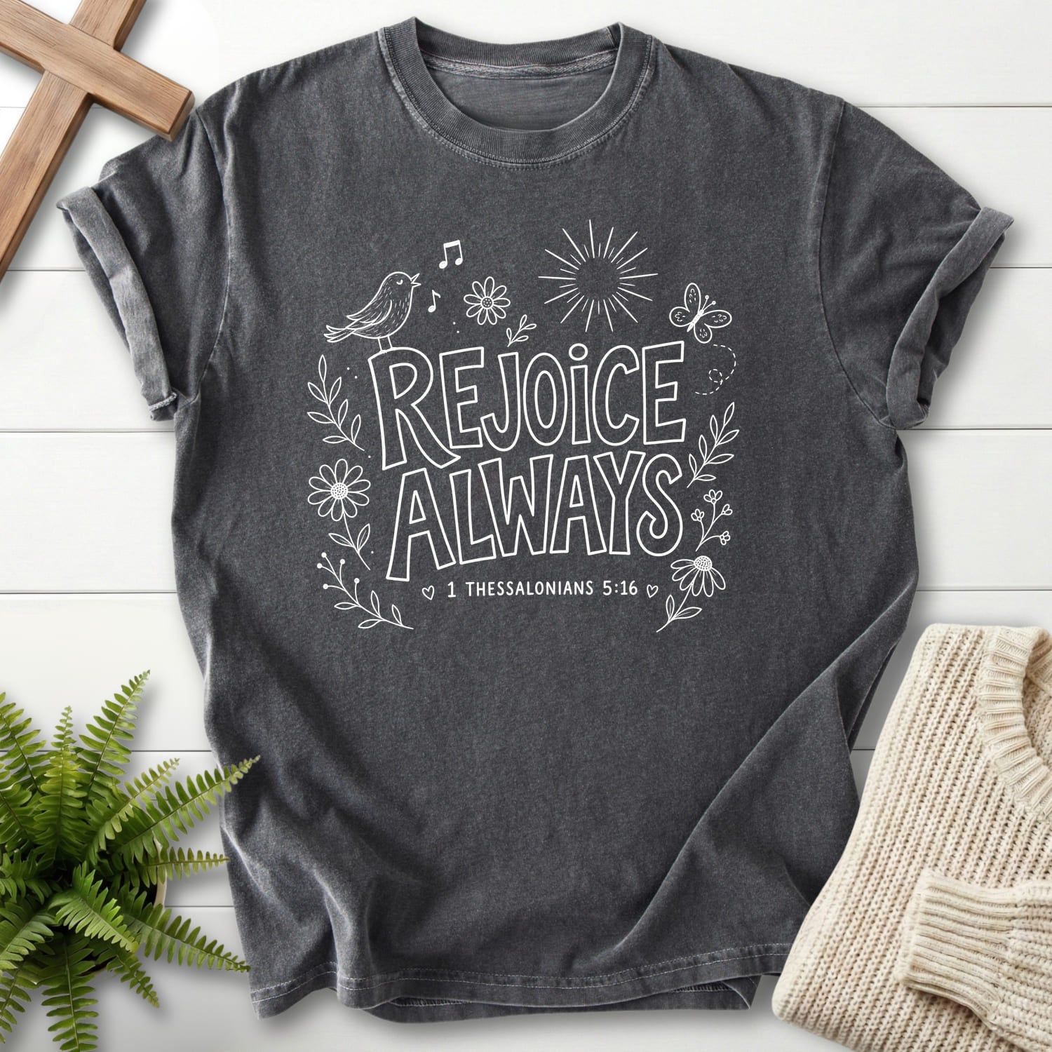 Flat lay of a Pepper Comfort Colors 1717 Christian graphic tee featuring butterfly artwork with "Rejoice Always T-Shirt" 1 Thessalonians 5:16.