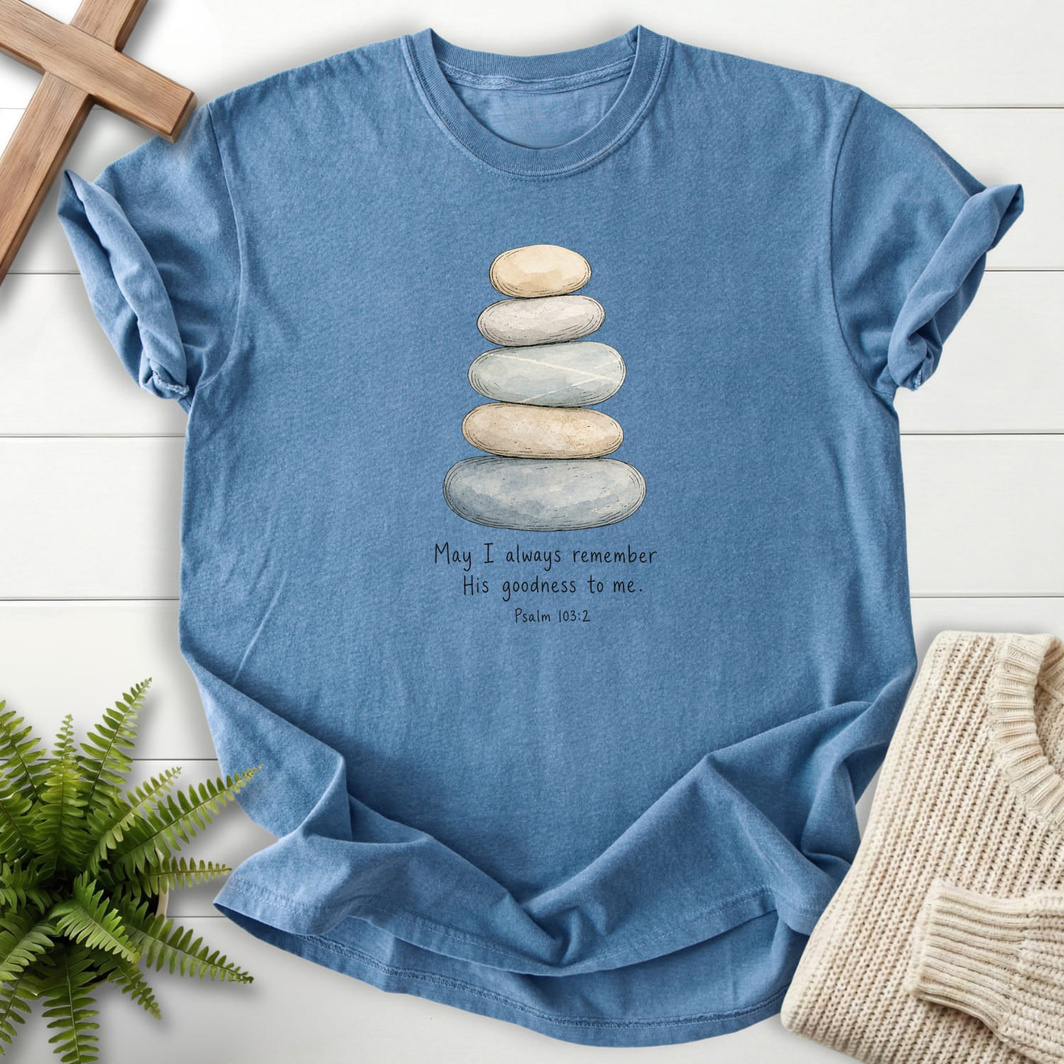 Flatlay of a Blue Jean faith-inspired shirt with "Remember His Goodness Dark T-Shirt" Psalm 103:2.