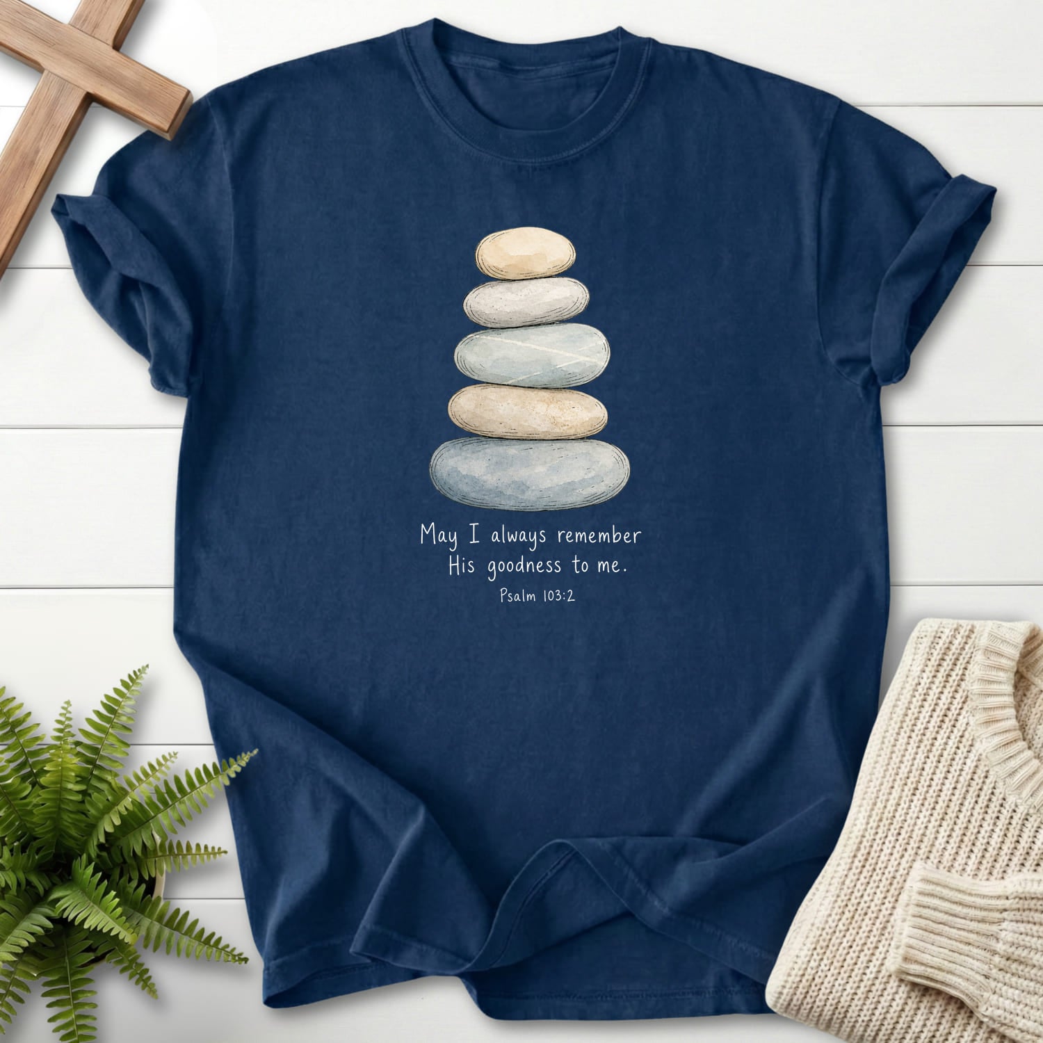 Flat lay of a Navy Christian t-shirt for women featuring "Remember His Goodness Dark T-Shirt" Psalm 103:2 From Printify.