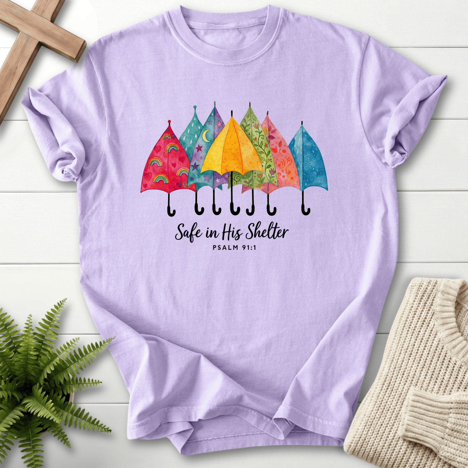 Orchid women's Bible verse tee with colorful patterned umbrellas, inspired by Psalm 91:1.
