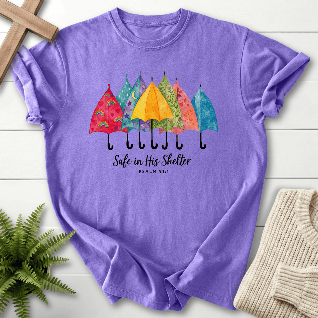Violet women's Christian t-shirt with whimsical umbrella row and "Safe in His Shelter," inspired by Psalm 91:1.