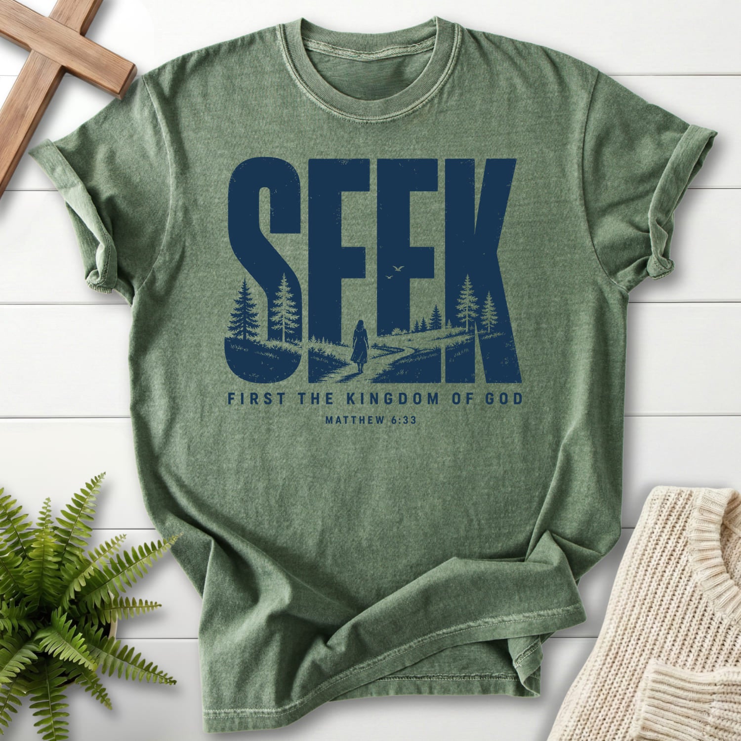 Flatlay of a Moss Christian t-shirt for women with "Seek First the Kingdom of God T-Shirt" Matthew 6:33 From Printify.