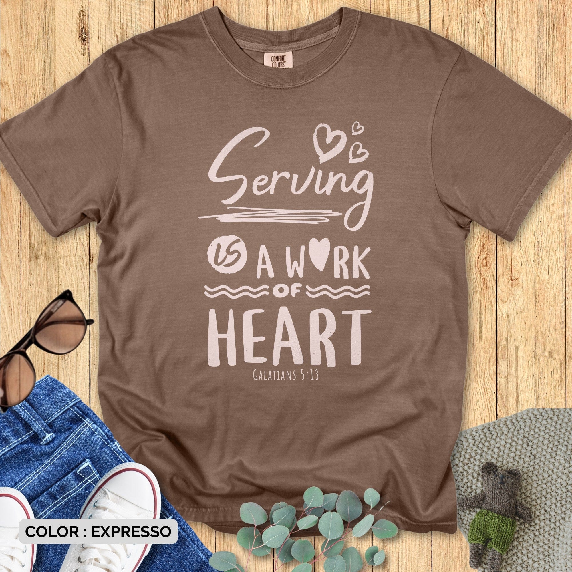 “Faith-inspired Comfort Colors 1717 Espresso brown t-shirt with ‘Serving Is a Work of Heart – Galatians 5:13’ message. Christian women’s wear for faith and gratitude.”