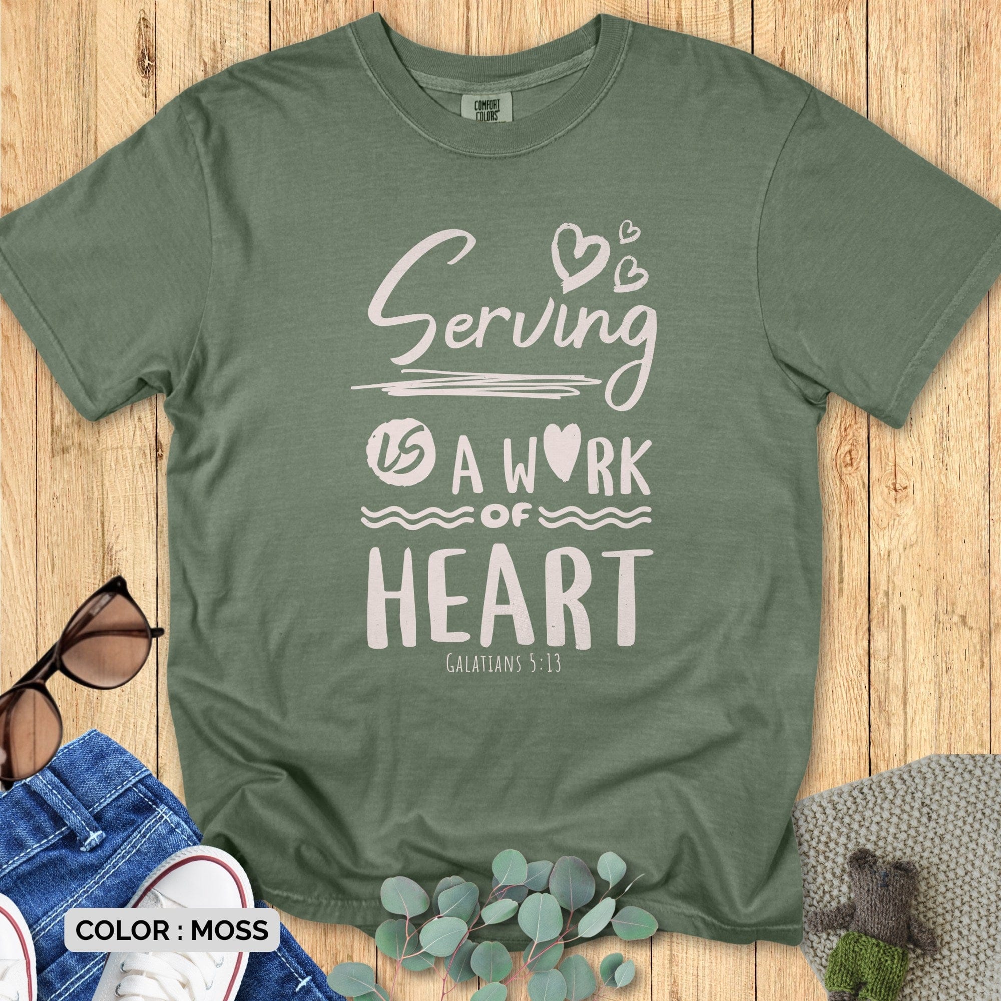 “Comfort Colors 1717 Moss Christian women t-shirt with uplifting ‘Serving Is a Work of Heart – Galatians 5:13’ verse. Soft, casual faith day wear for serving hearts.”
