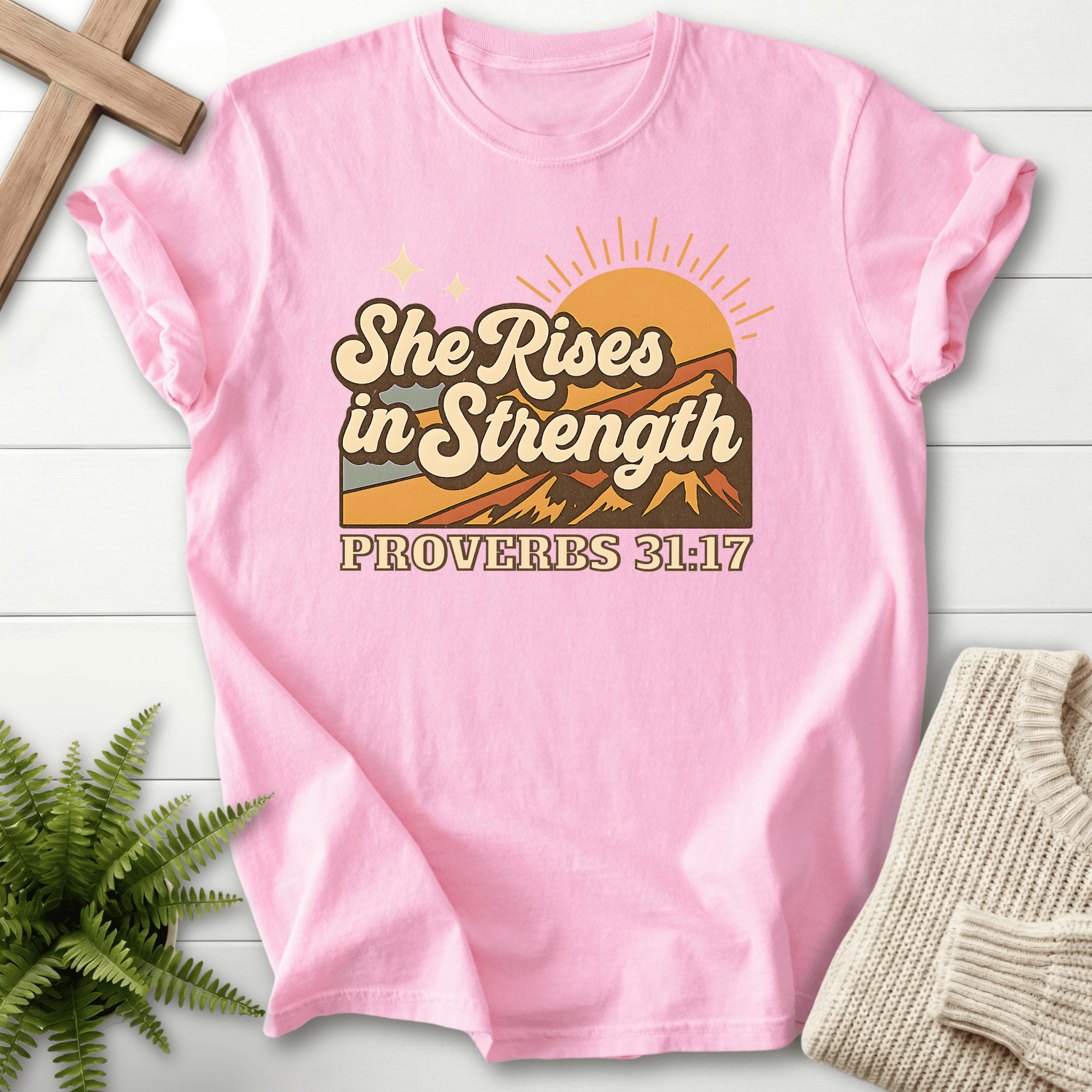 Blossom women's Scripture shirt with retro sunrise mountain scene, inspired by Proverbs 31:17.