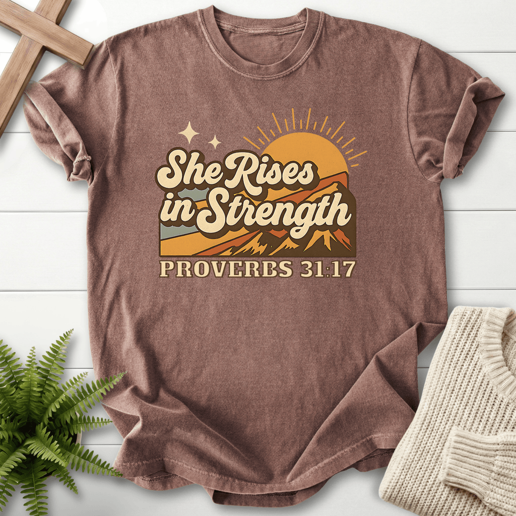 Espresso women's Bible verse tee with vintage sun and mountains and "She Rises in Strength," inspired by Proverbs 31:17.